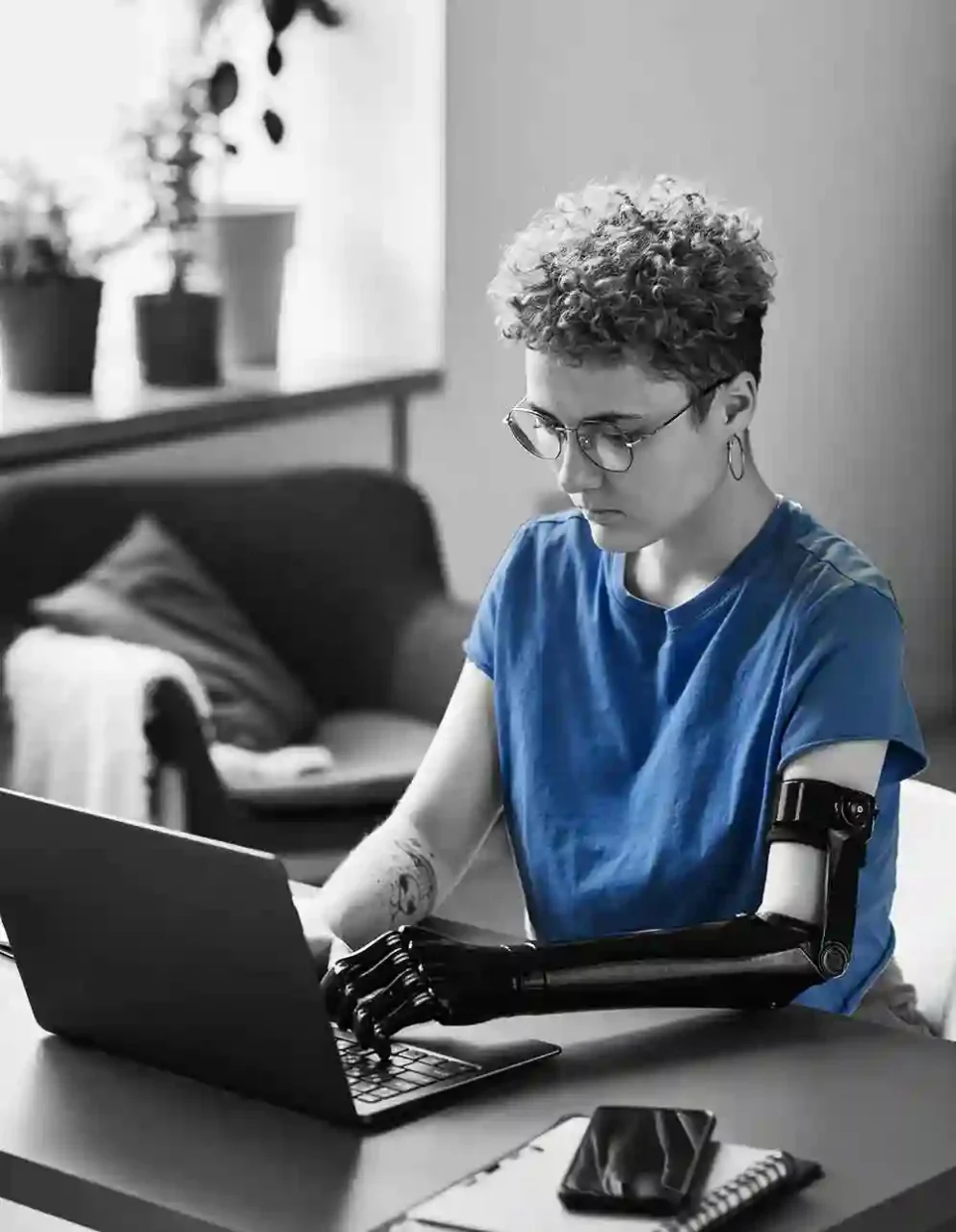 woman with prosthetic arm at computer